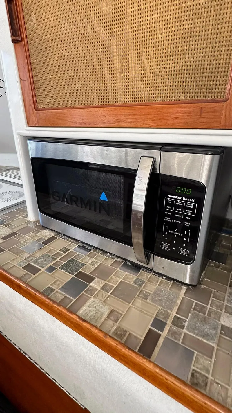 Slide: The Image of Microwave on tiled countertop inside 1979 Buddy Davis 46 Convertible boat kitchen. - 14