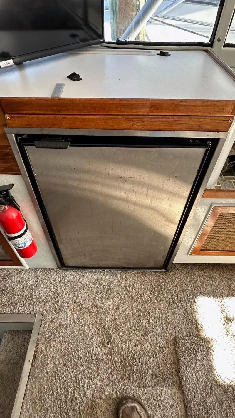 Slide: The Image of 1979 Buddy Davis 46 Convertible interior with mini fridge and fire extinguisher. - 15