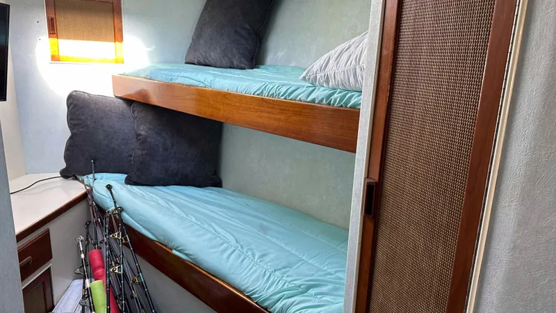Slide: The Image of Interior of 1979 Buddy Davis 46 Convertible with bunk beds and fishing rods. - 18