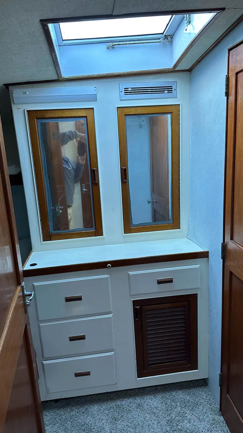 Slide: The Image of 1979 Buddy Davis 46 Convertible interior with skylight, mirrors, and wooden cabinetry. - 19