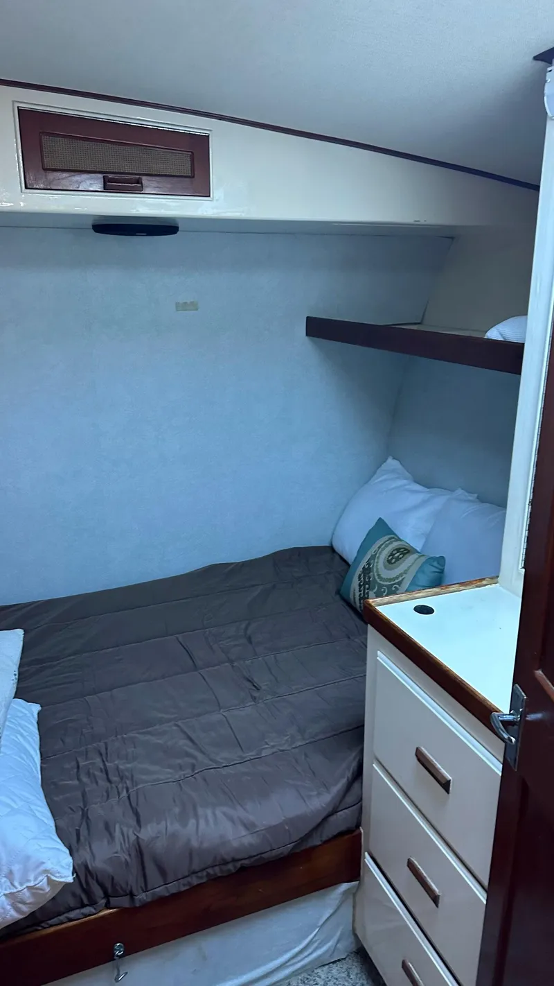 Slide: The Image of Cozy cabin interior of 1979 Buddy Davis 46 Convertible boat with bed and storage. - 22