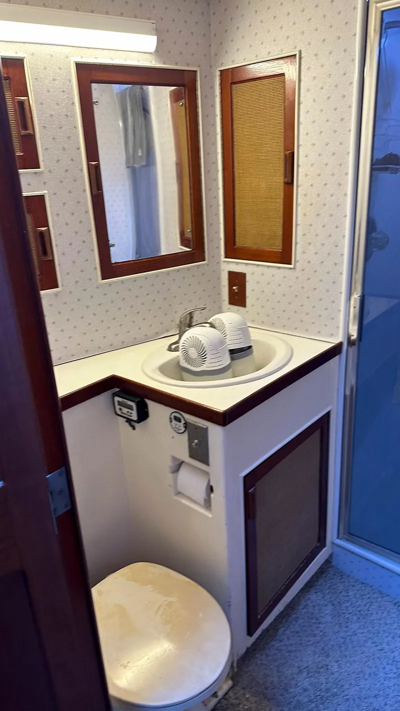 Slide: The Image of 1979 Buddy Davis 46 Convertible yacht bathroom with sink, mirror, and shower. - 23