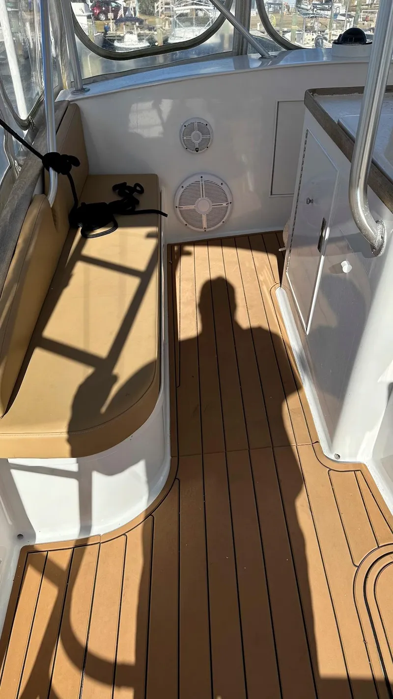 Slide: The Image of 1979 Buddy Davis 46 Convertible boat interior with teak flooring and cushioned seating. - 6