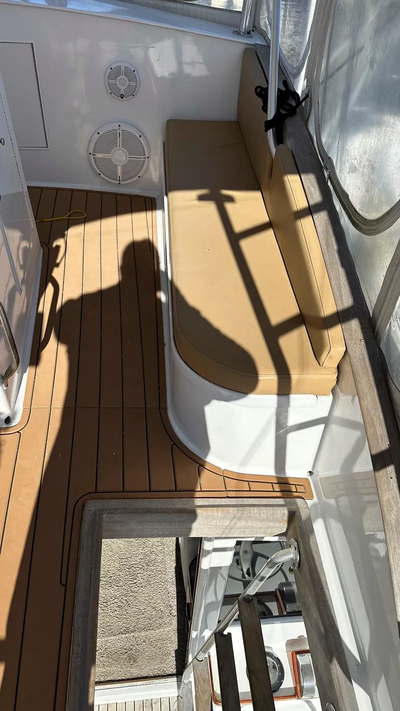 Slide: The Image of 1979 Buddy Davis 46 Convertible boat interior with tan seating and wooden flooring. - 7
