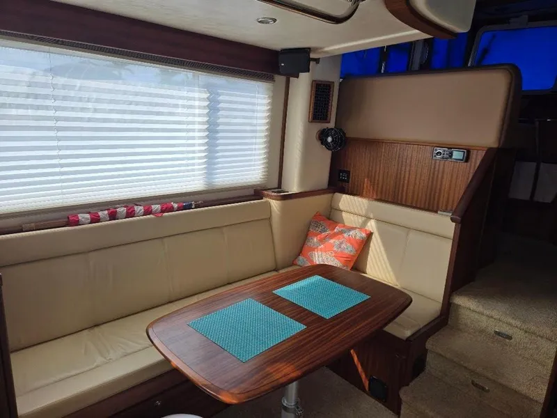 Slide: The Image of Interior of 2015 American Tug 365 Flybridge with cozy seating and wooden table. - 12