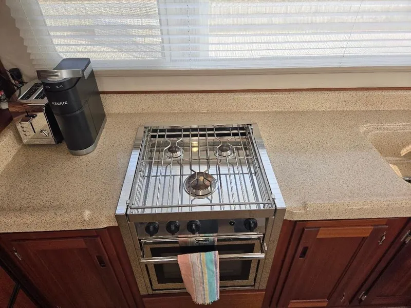 Slide: The Image of Kitchen area of 2015 American Tug 365 Flybridge with stove, coffee maker, and toaster. - 14