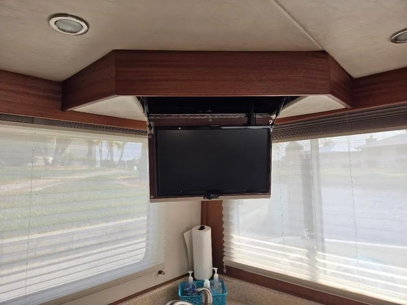 Slide: The Image of Interior of 2015 American Tug 365 Flybridge with mounted TV and large windows. - 17