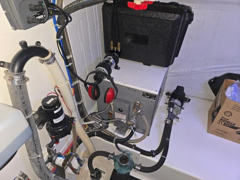 Slide: The Image of Engine room of 2015 American Tug 365 Flybridge with various mechanical components. - 19