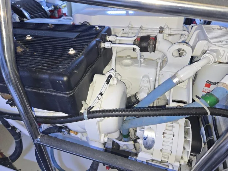 Slide: The Image of Engine compartment of a 2015 American Tug 365 Flybridge, showcasing mechanical components and wiring. - 21