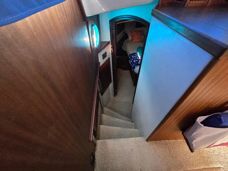 Slide: The Image of Interior stairs of 2015 American Tug 365 Flybridge, leading to cozy cabin area. - 28