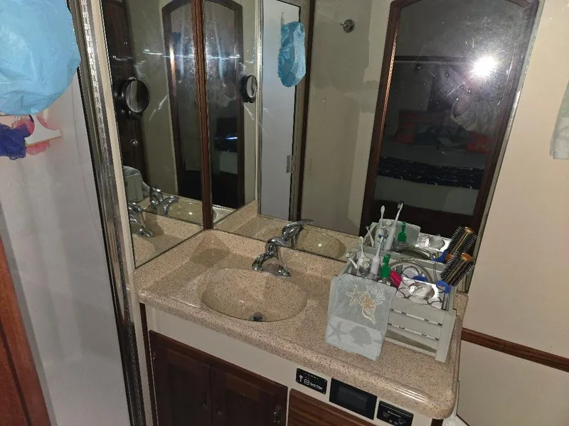 Slide: The Image of Bathroom vanity with sink and mirror in 2015 American Tug 365 Flybridge. - 30