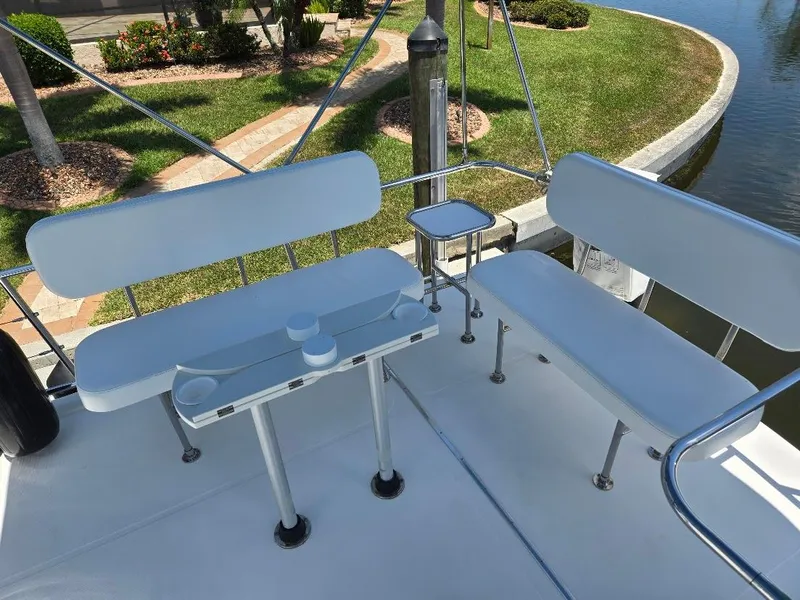 Slide: The Image of Flybridge seating area on 2015 American Tug 365, featuring white benches and table. - 32