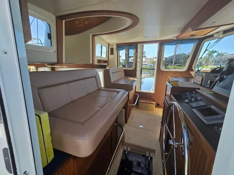 Slide: The Image of Interior of 2015 American Tug 365 Flybridge with plush seating and navigation controls. - 6
