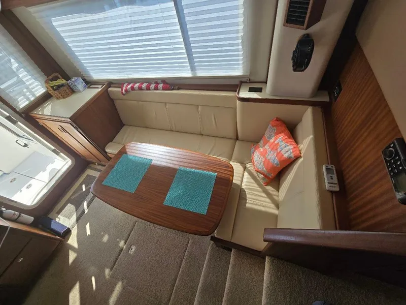 Slide: The Image of Interior of 2015 American Tug 365 Flybridge with cozy seating and wooden table. - 7