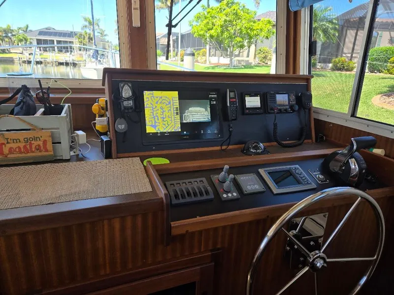 Slide: The Image of Pilothouse of 2015 American Tug 365 Flybridge with navigation equipment and steering wheel. - 9