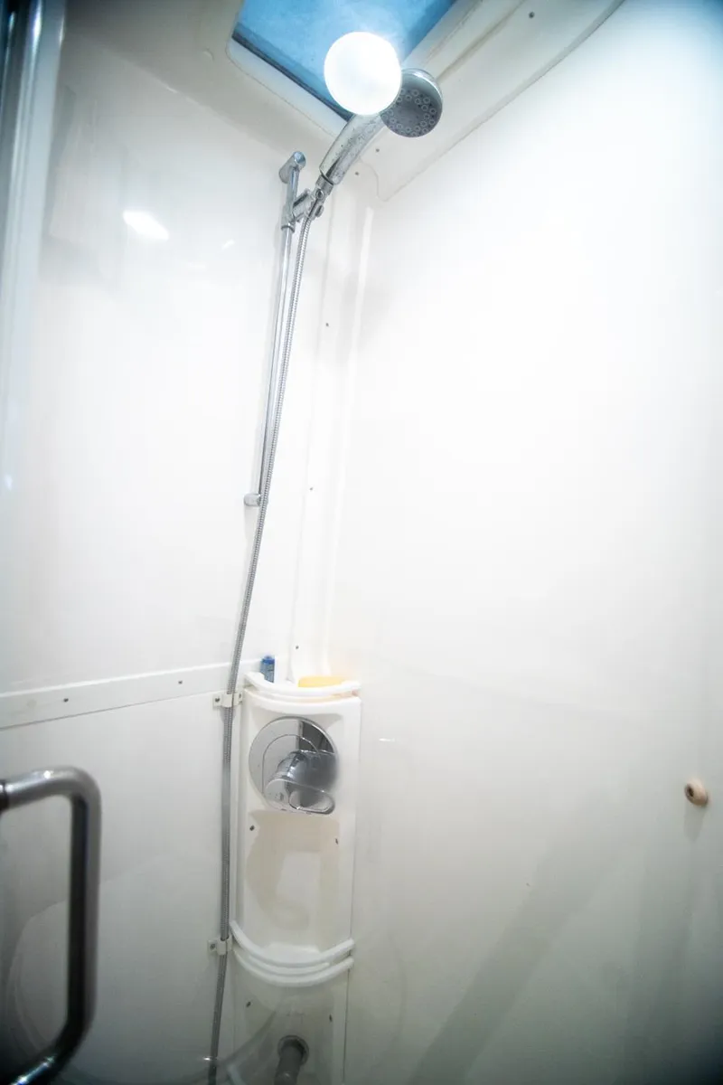 Slide: The Image of Shower area in a 2006 Intrepid 377 WA boat, featuring a sleek, modern design. - 14