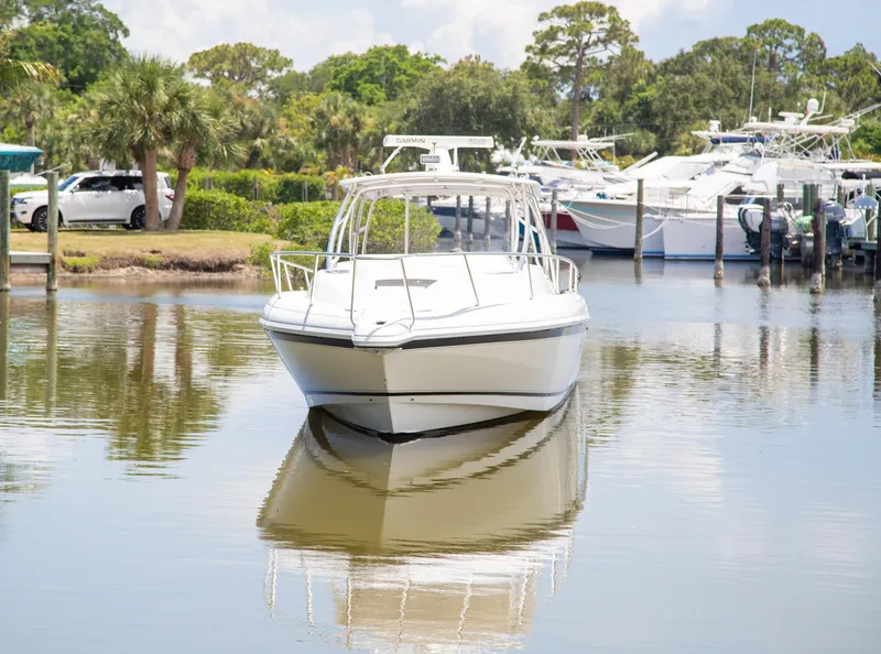 Slide: The Image of 2006 Intrepid 377 WA boat docked in a serene marina setting. - 15