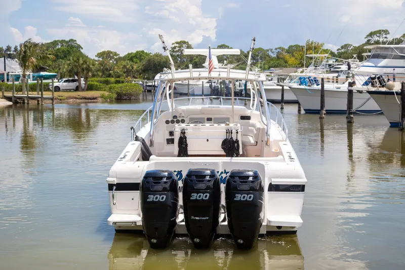 Slide: The Image of 2006 Intrepid 377 WA boat docked in a marina under a clear blue sky. - 2