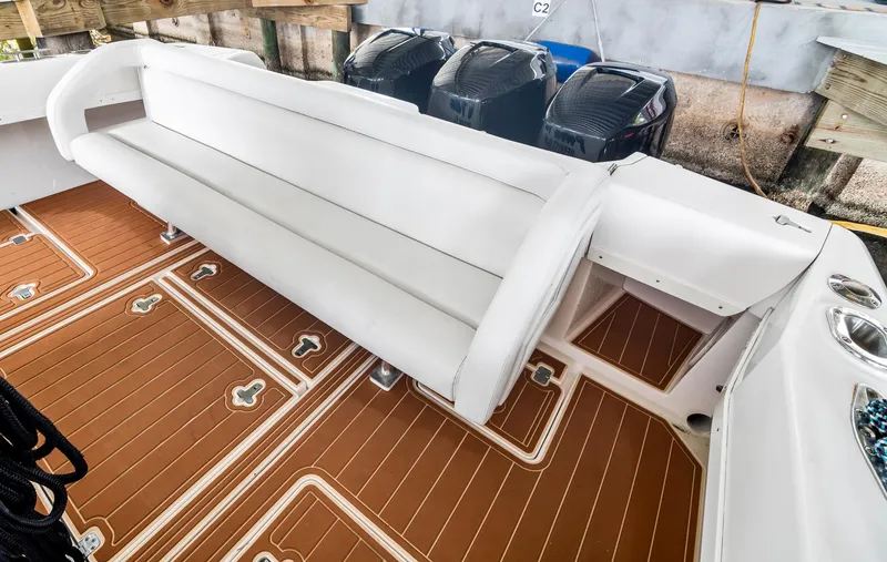Slide: The Image of 2006 Intrepid 377 WA boat interior with white seating and brown deck flooring. - 3