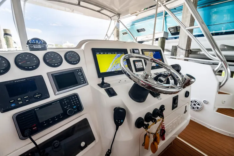Slide: The Image of 2006 Intrepid 377 WA boat dashboard with navigation instruments and steering wheel. - 6