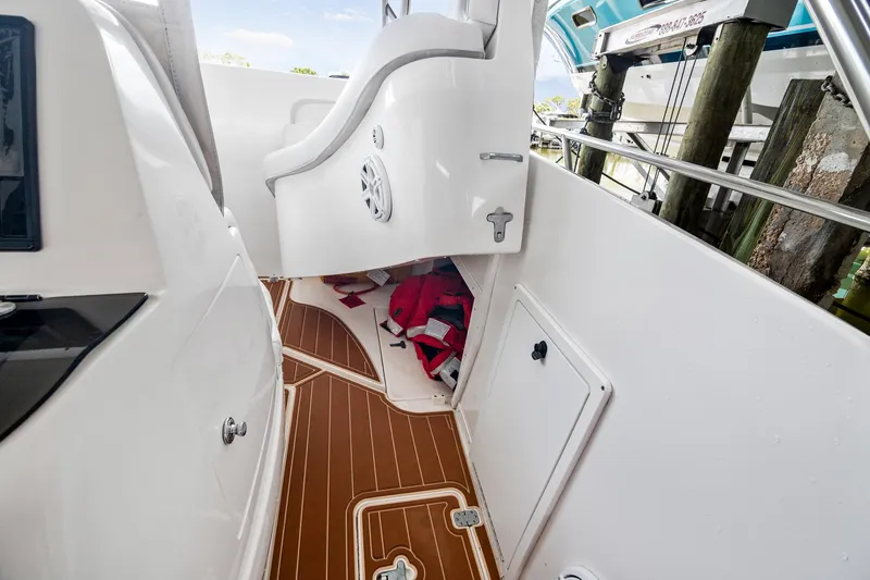 Slide: The Image of Interior view of a 2006 Intrepid 377 WA boat with wood flooring and storage compartments. - 7
