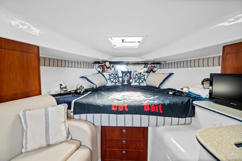 Slide: The Image of Interior of a 2006 Intrepid 377 WA boat with cozy bed and nautical decor. - 9