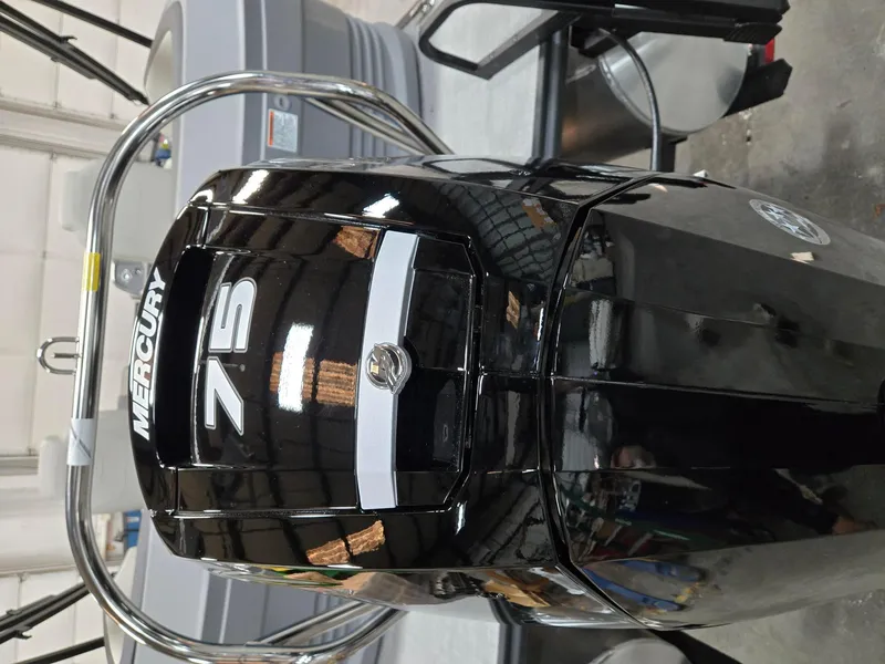 Slide: The Image of Mercury 7.5 outboard motor on 2025 Starcraft GX20R boat in showroom. - 8