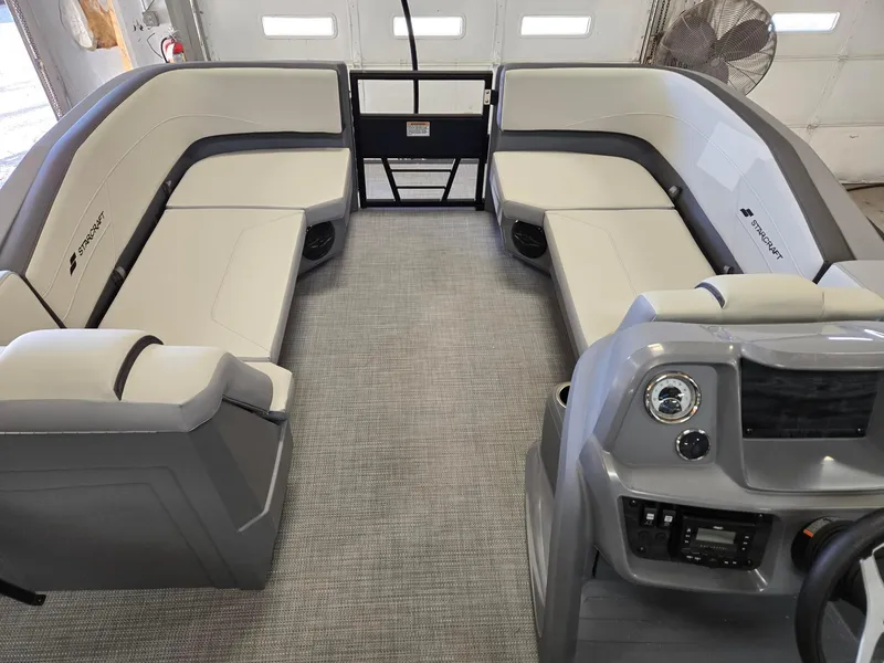 Slide: The Image of 2025 Starcraft GX22R boat interior with gray seating and modern dashboard. - 10