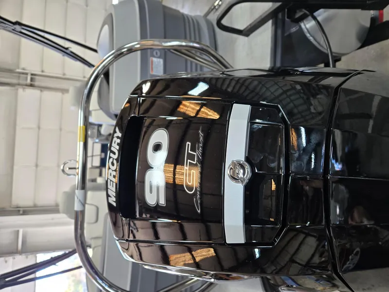Slide: The Image of Mercury 90 CT outboard motor on 2025 Starcraft GX22R boat in showroom. - 5