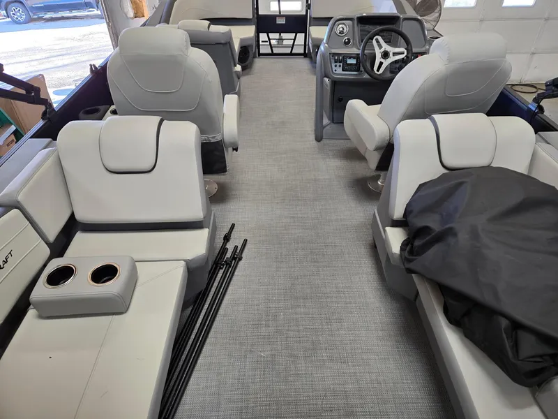 Slide: The Image of Interior of 2025 Starcraft GX22R boat with modern seating and steering console. - 8