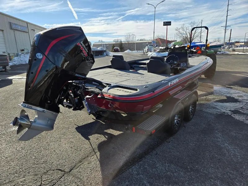 Slide: The Image of 2025 Falcon Boats F205 on trailer, featuring powerful outboard motor, parked outdoors. - 4