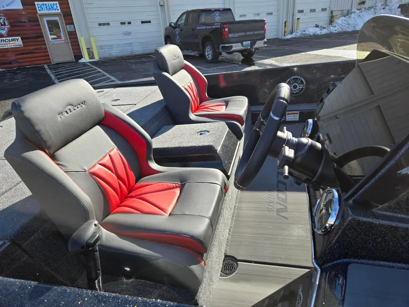 Slide: The Image of 2025 Falcon Boats F205 interior with red and gray seats, steering wheel, and dashboard. - 7