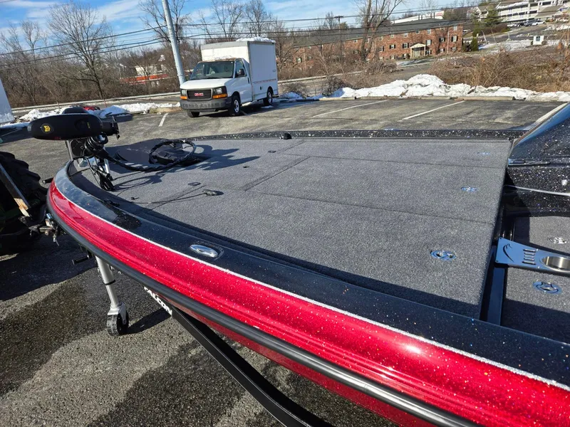 Slide: The Image of 2025 Falcon Boats F205 with red trim, parked outdoors on a sunny day. - 8