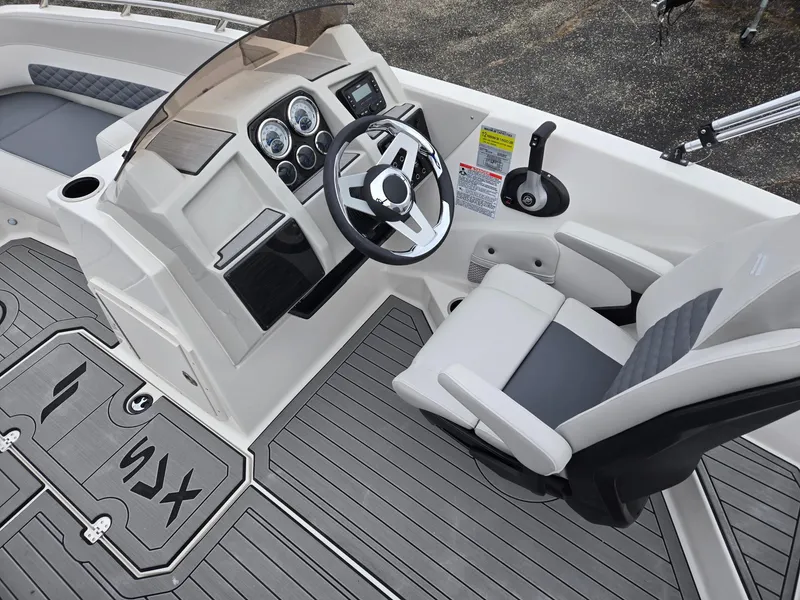 Slide: The Image of 2025 Starcraft SVX191 boat cockpit with steering wheel, gauges, and seating. - 8