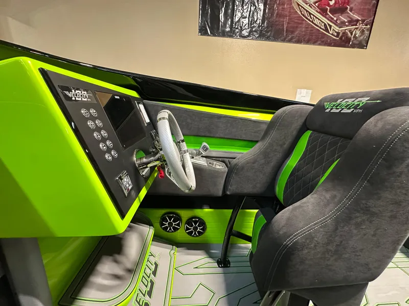 Slide: The Image of Interior of 2025 Velocity 40 RAPTOR boat with green accents and modern dashboard. - 10