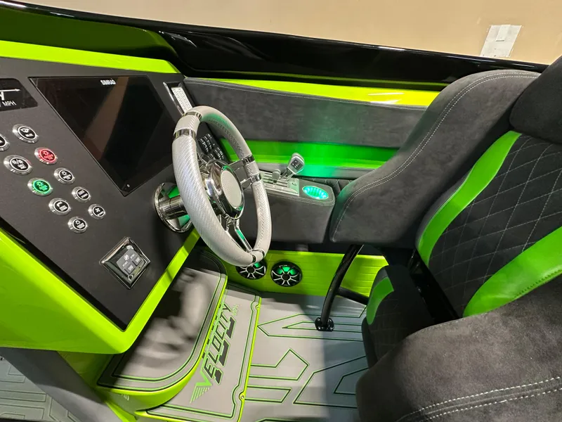 Slide: The Image of 2025 Velocity 40 RAPTOR cockpit with vibrant green accents and modern dashboard controls. - 11