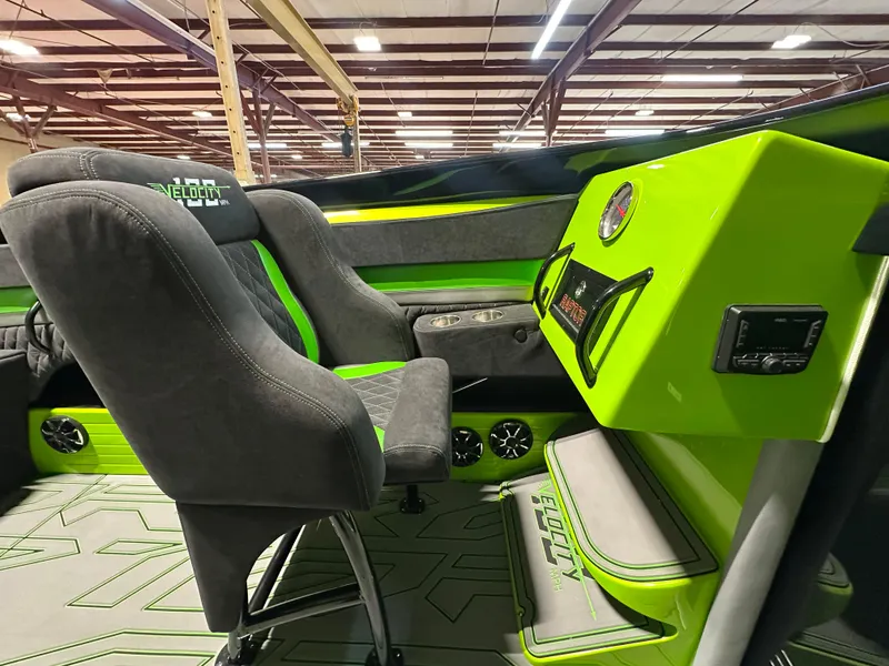 Slide: The Image of Interior of 2025 Velocity 40 RAPTOR boat with green accents and modern seating. - 13