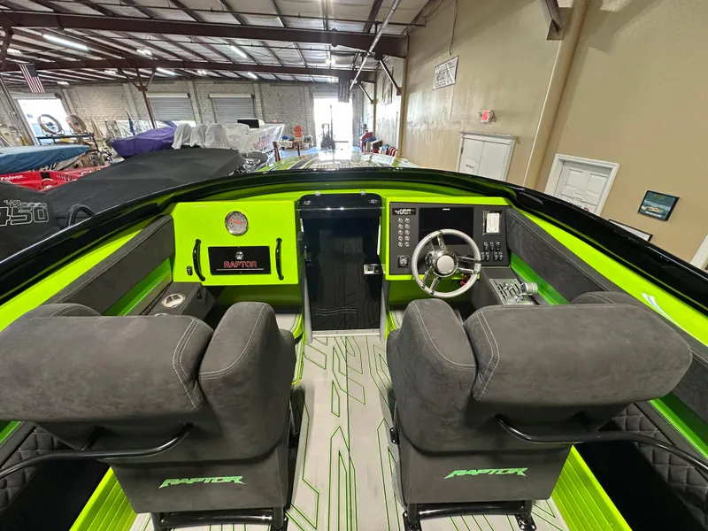 Slide: The Image of 2025 Velocity 40 RAPTOR boat interior with green accents and modern dashboard controls. - 15