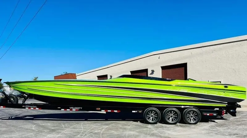 Slide: The Image of 2025 Velocity 40 RAPTOR speedboat in vibrant green on a trailer, parked outdoors. - 3