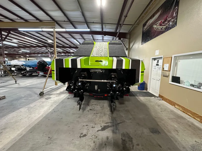 Slide: The Image of 2025 Velocity 40 RAPTOR boat in a workshop, showcasing its sleek design and vibrant colors. - 30