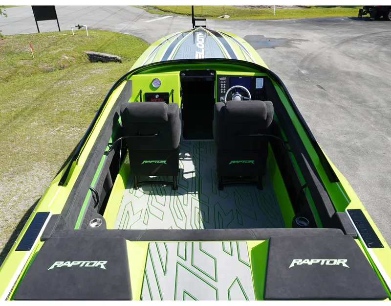 Slide: The Image of 2025 Velocity 40 RAPTOR boat interior with green accents and dual seating. - 4