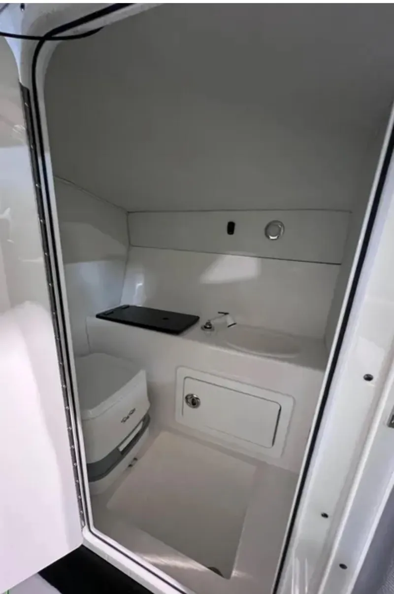 Slide: The Image of Compact bathroom in 2025 Velocity 40 RAPTOR boat, featuring sink and storage. - 42
