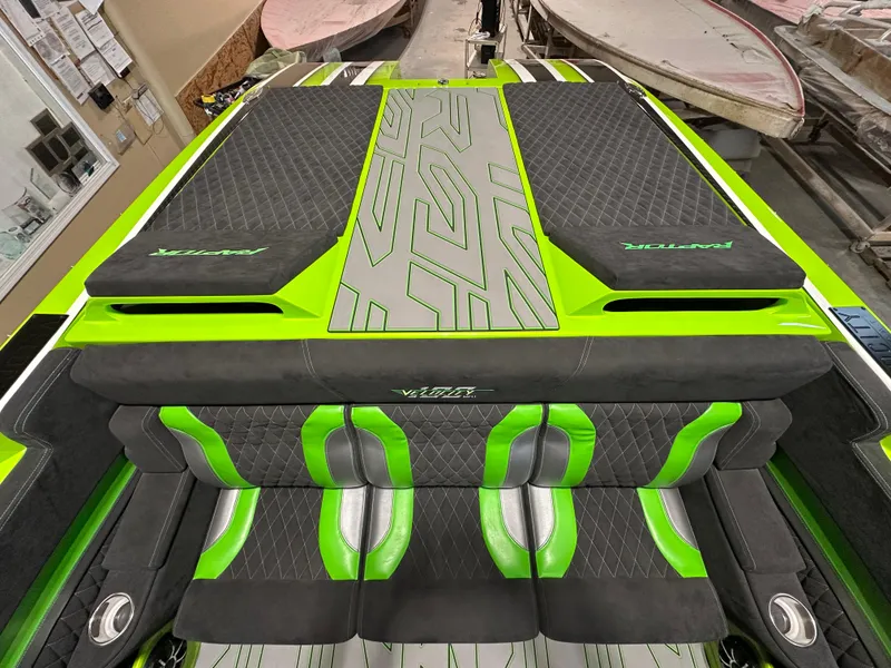 Slide: The Image of 2025 Velocity 40 RAPTOR boat interior with green and black seating and stylish design. - 7