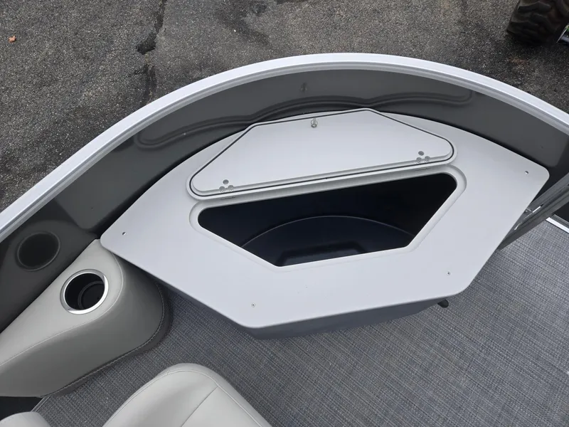 Slide: The Image of Starcraft EX20FD4 2025 boat storage compartment with cup holder on deck. - 10