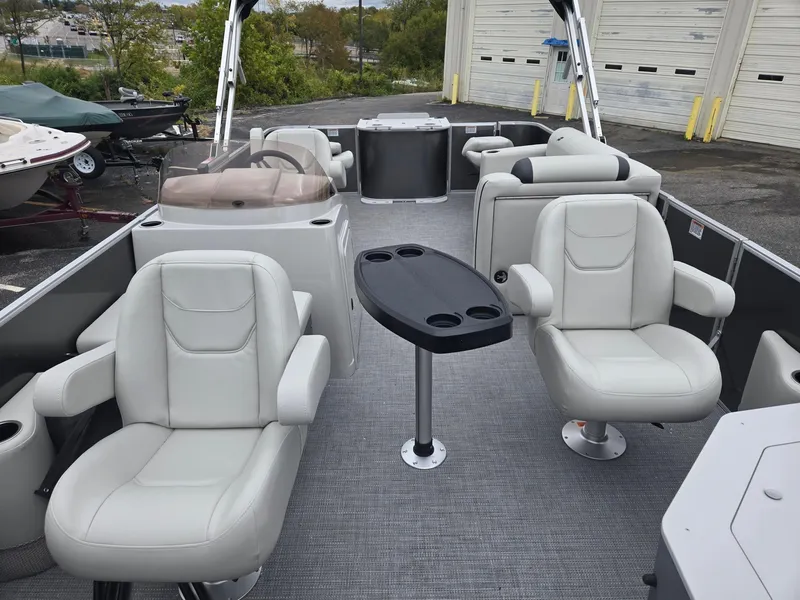 Slide: The Image of Interior of 2025 Starcraft EX20FD4 pontoon boat with plush seating and table. - 6