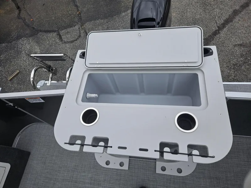 Slide: The Image of 2025 Starcraft EX20FD4 boat with open storage compartment and cup holders on deck. - 8