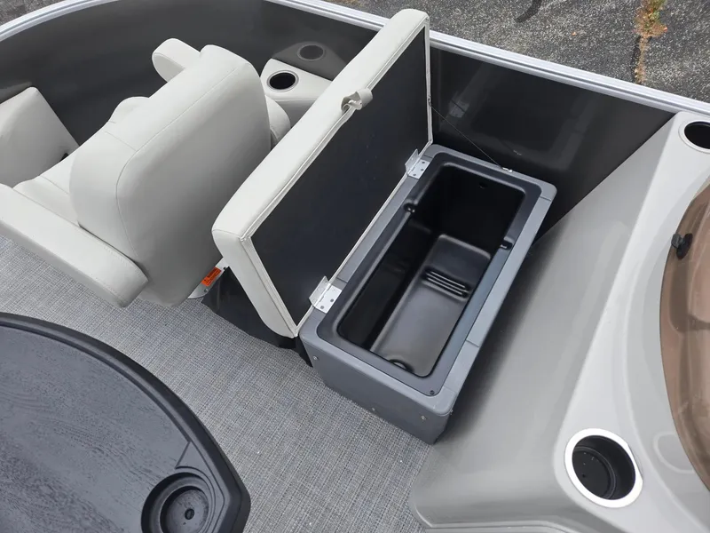 Slide: The Image of Starcraft EX20FD4 2025 boat interior with open storage compartment and seating. - 9