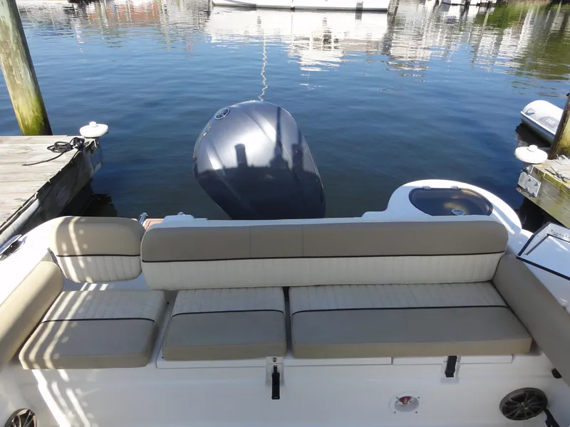 Slide: The Image of 2017 Sea Fox 249 Avenger boat with beige seating, docked by the water. - 10