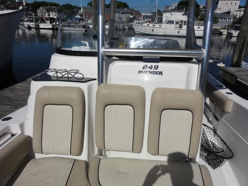 Slide: The Image of 2017 Sea Fox 249 Avenger boat interior with beige seating at a marina. - 12