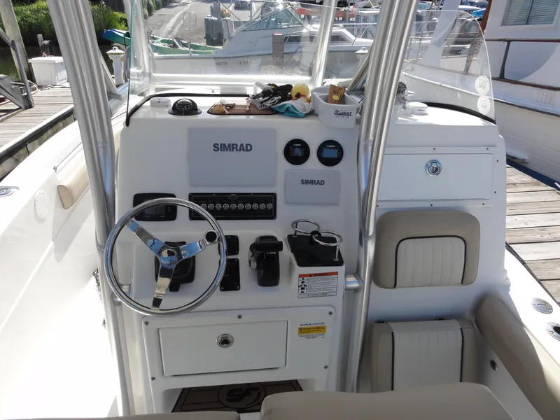 Slide: The Image of 2017 Sea Fox 249 Avenger boat dashboard with steering wheel and Simrad electronics. - 13